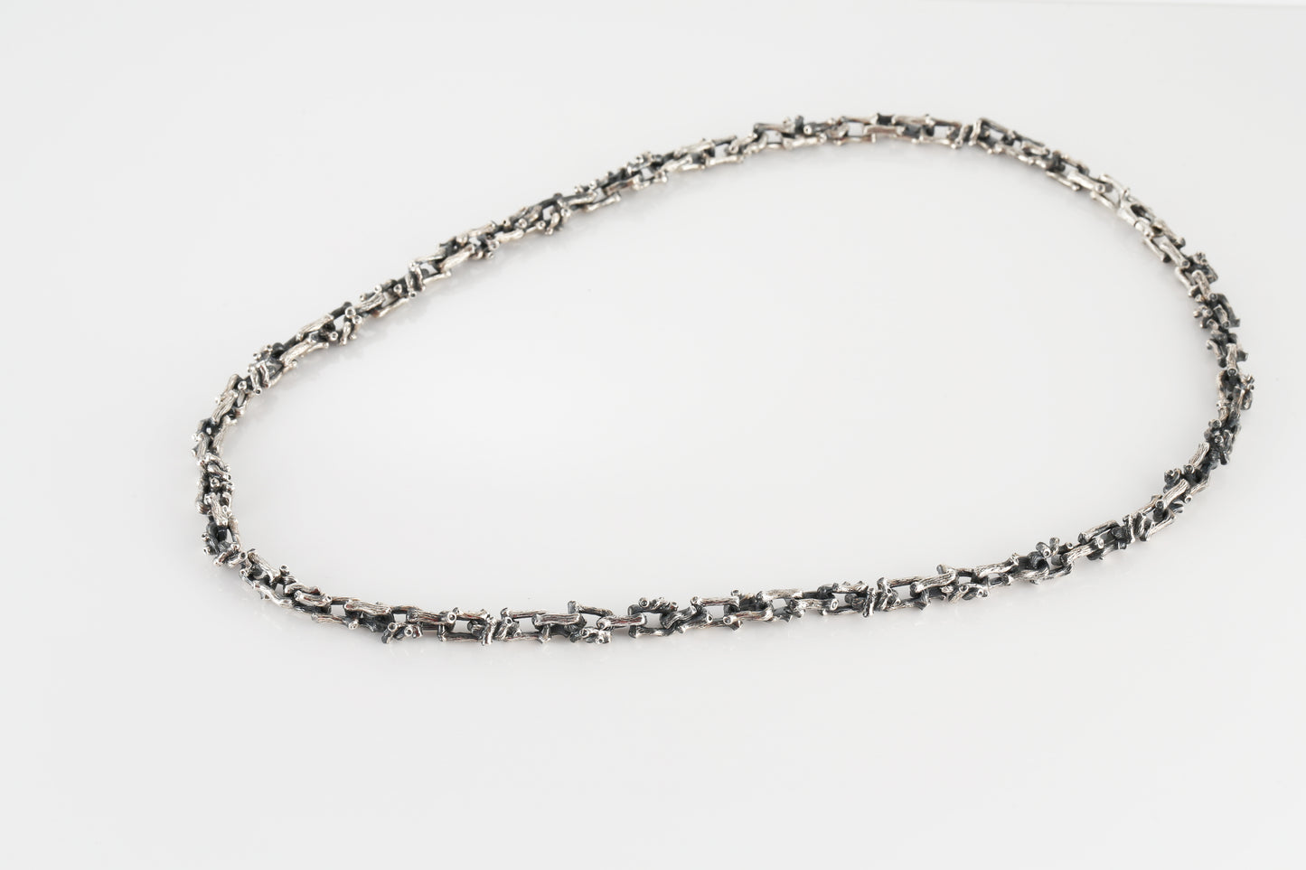 Silver necklace in the shape of a branch