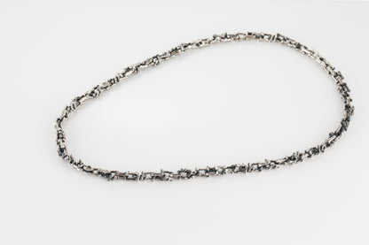 Silver necklace in the shape of a branch