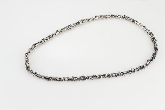Silver necklace in the shape of a branch