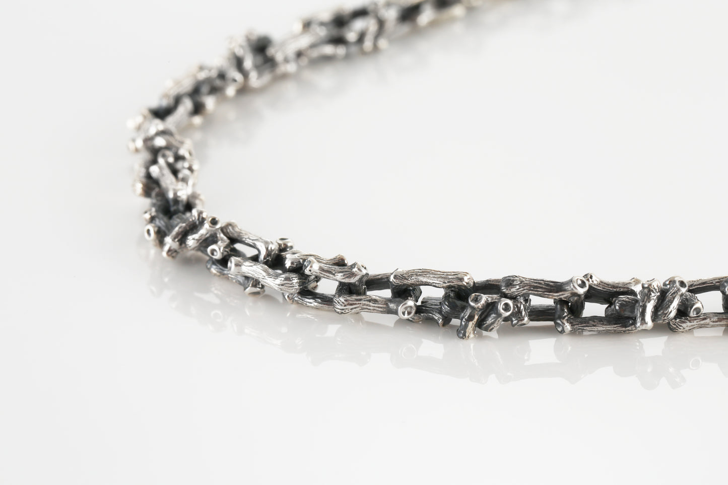 Silver necklace in the shape of a branch