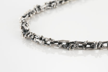 Silver necklace in the shape of a branch