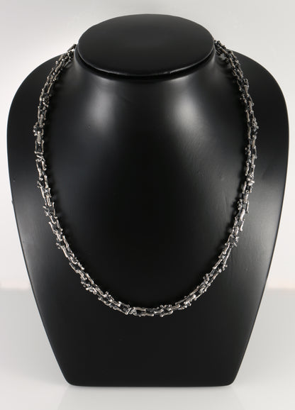 Silver necklace in the shape of a branch